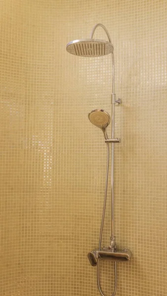Rain shower in luxury bathroom with green mosaic tile