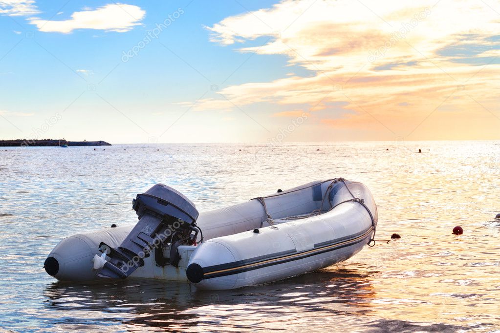 Inflatable boat with a motor in the bay