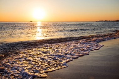 Dalgalar deniz kumlu plajda haddelenmiş