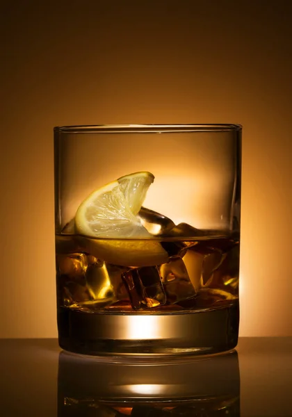 A glass of cocktail with lemon and ice — Stock Photo, Image