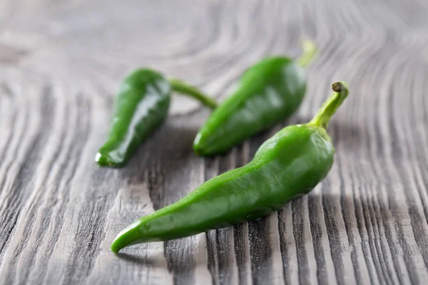 Green hot pepper on a wooden table