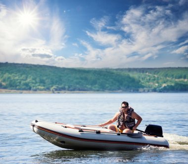 Man on an inflatable motor boat clipart