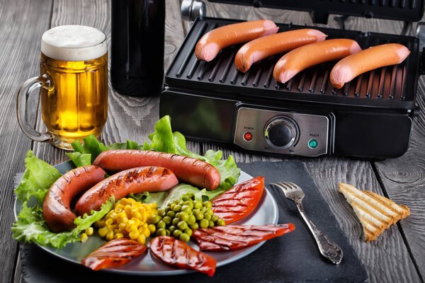Fried sausages with glass of light beer