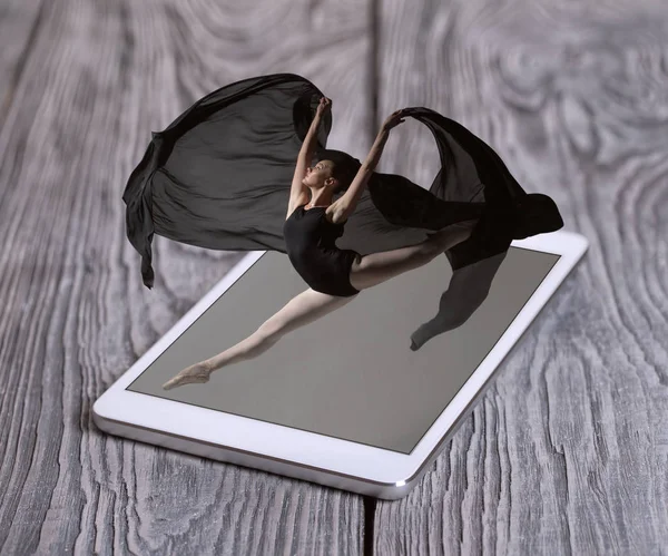 Gorgeous ballerina jumping from the phone — Stock Photo, Image