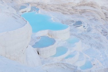 Blue water in Pamukkale travertine pools clipart