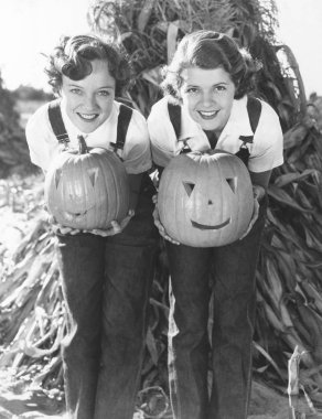  women holding Halloween pumpkins clipart