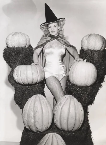 Woman with pumpkins on shelves — Stock Photo, Image