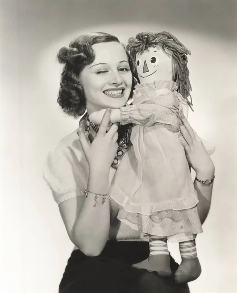 Smiling woman with doll — Stock Photo, Image