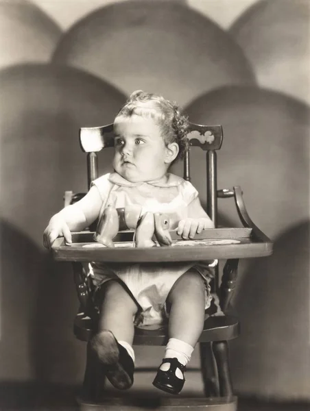 Baby sitting on chair — Stock Photo, Image