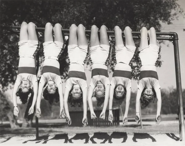 Girls hanging upside down Stock Picture