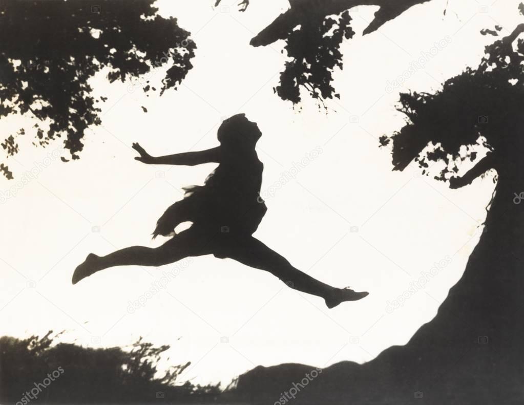  woman jumping against sky