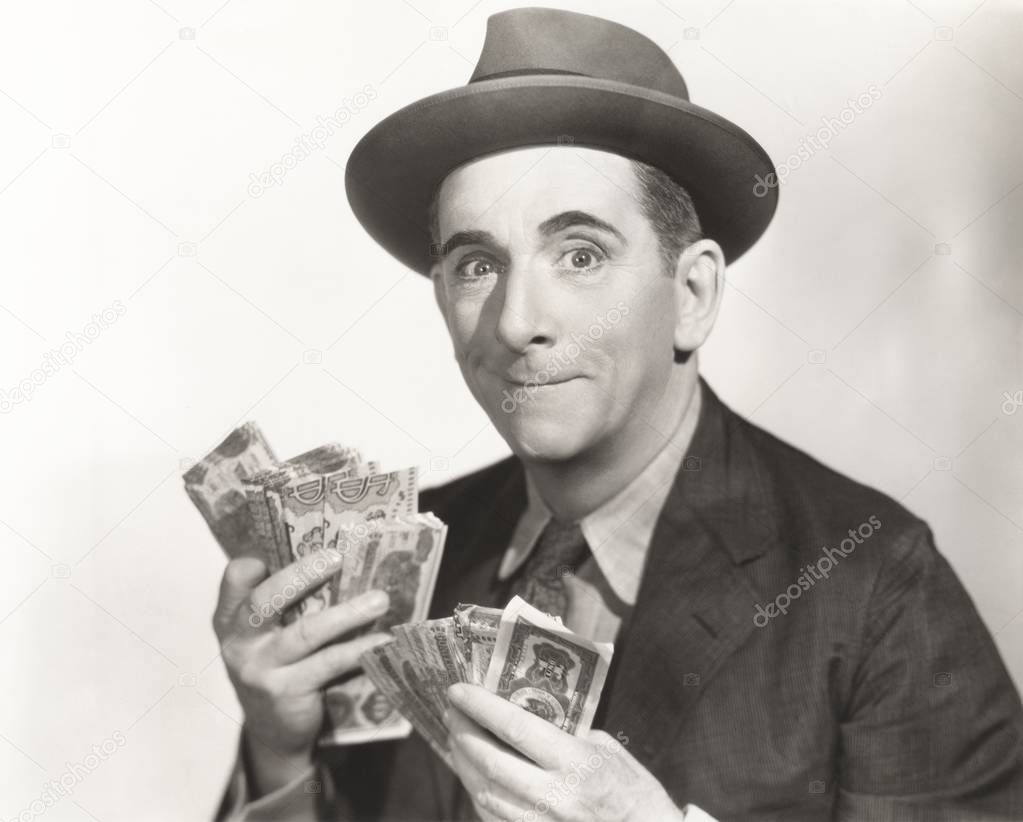  man holding paper currency 