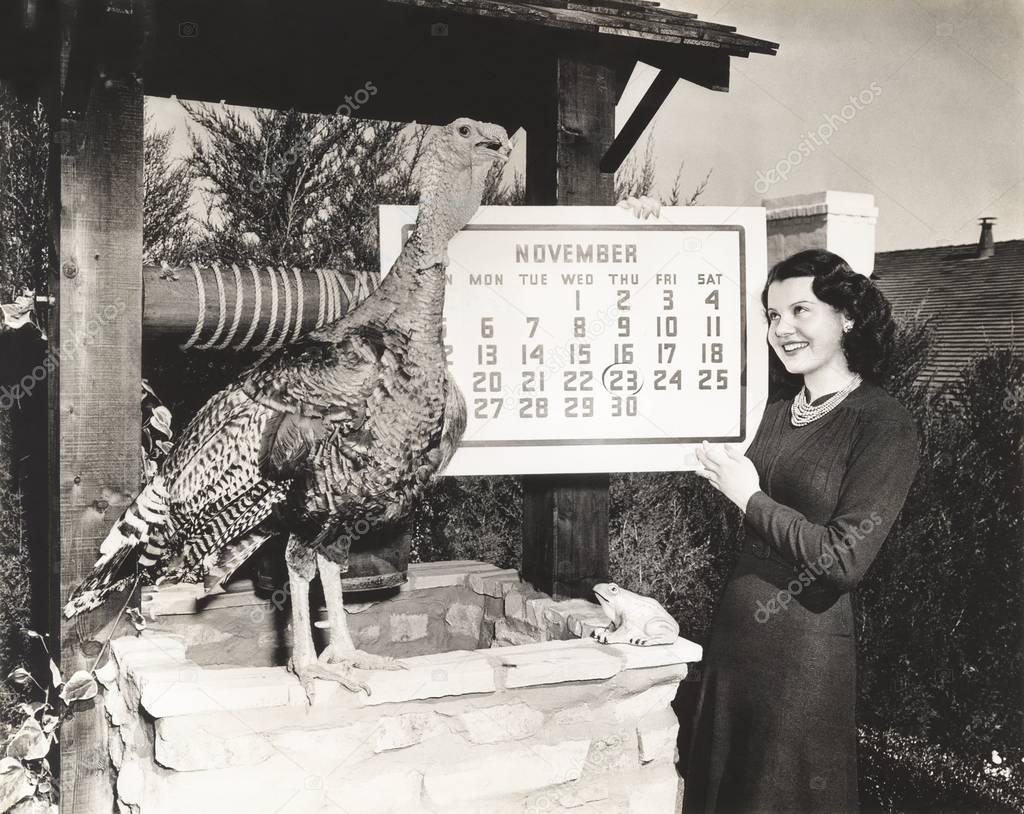 woman holding calendar while looking at turkey