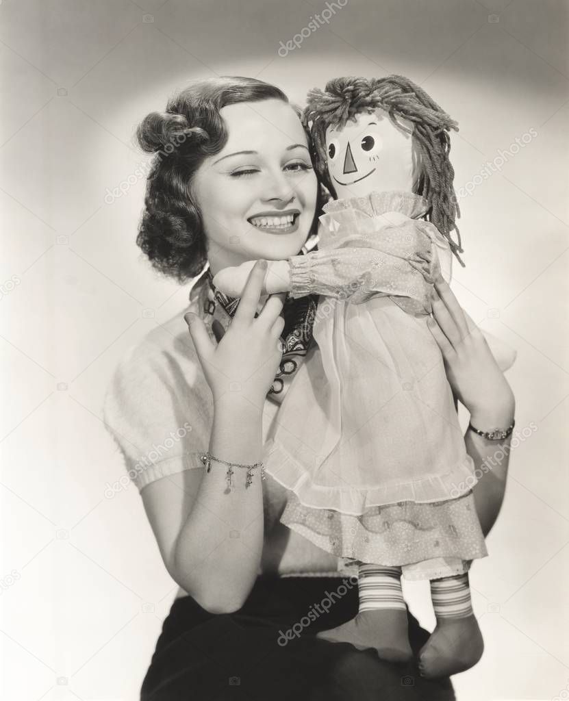 smiling woman with doll