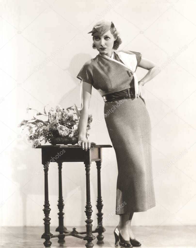 woman standing by side table