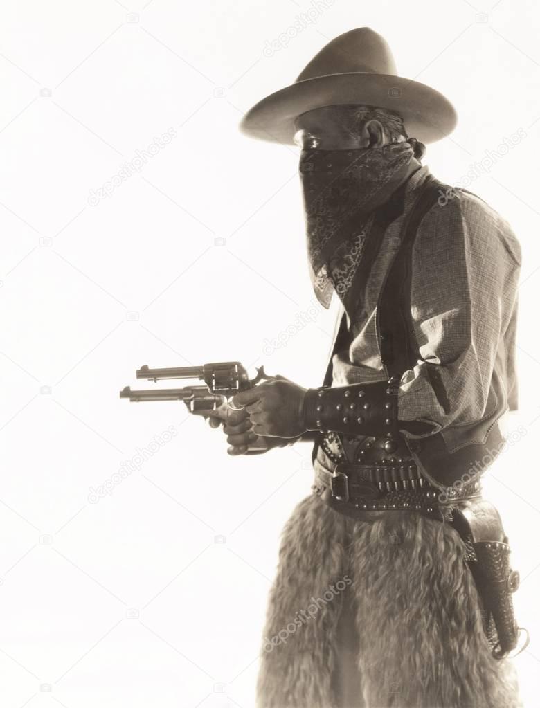 cowboy costume holding guns