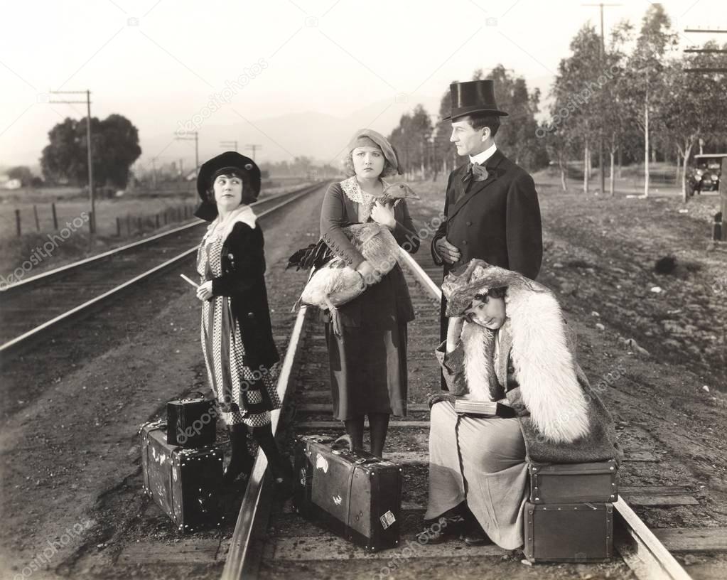 Women and man on railway tracks