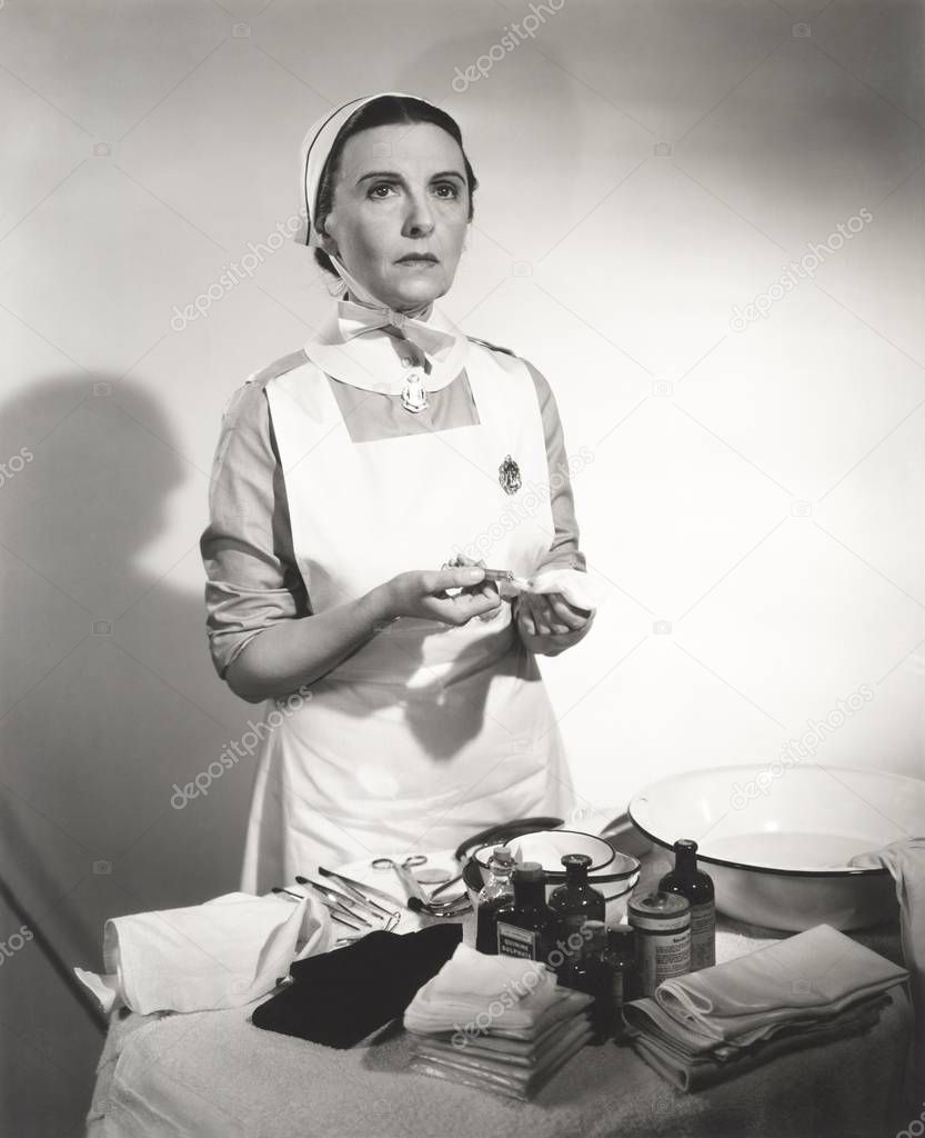 nurse holding syringe by medical tools