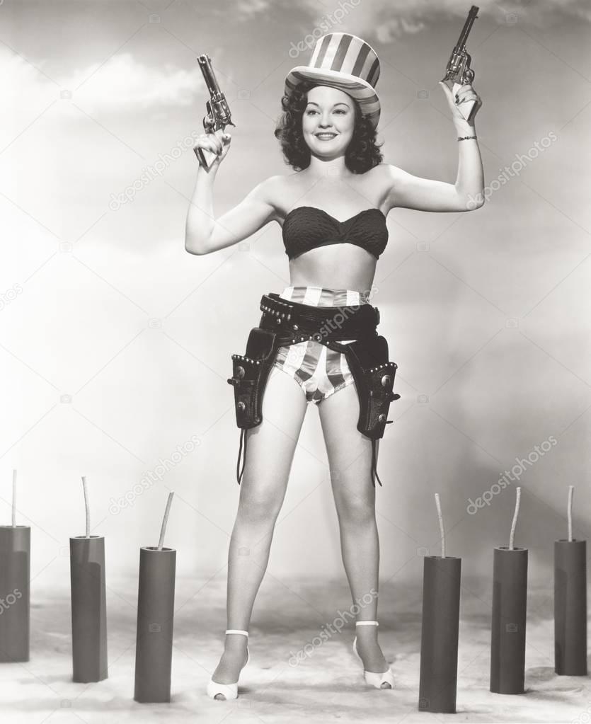 woman in bikini holding guns 