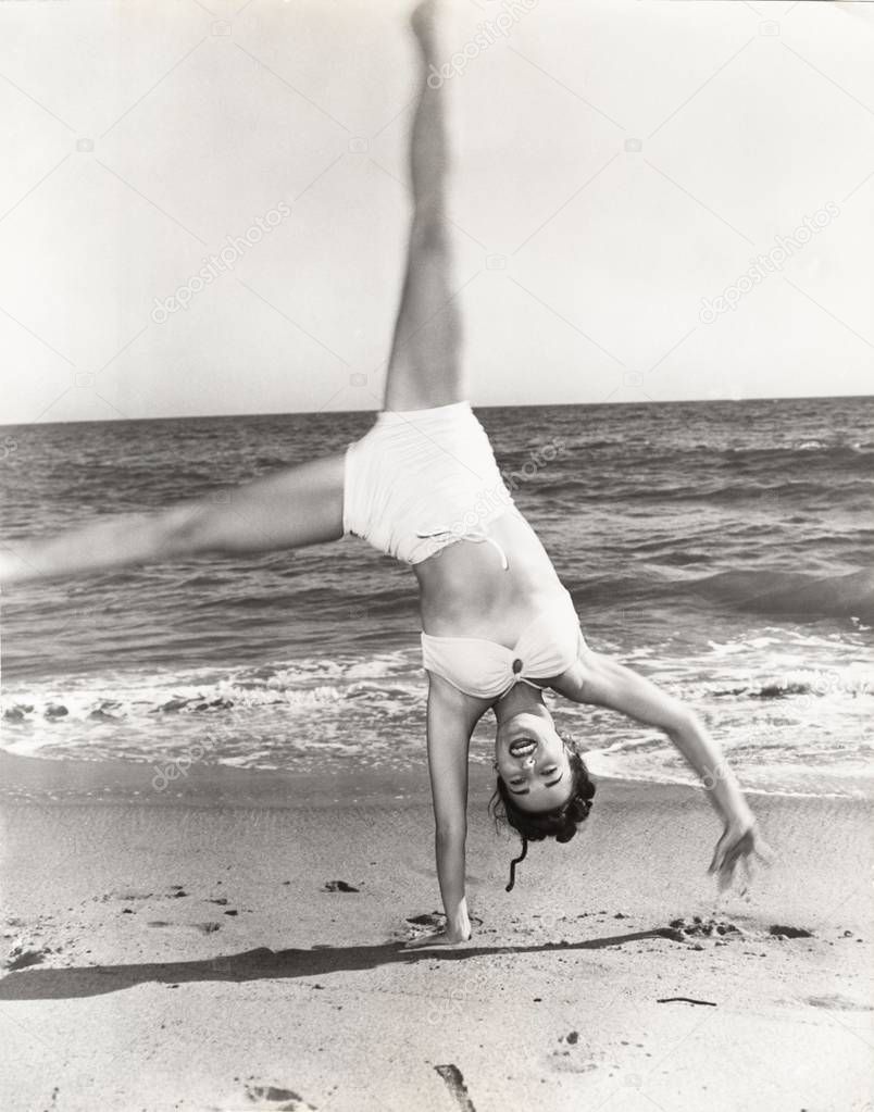  woman performing handstand 