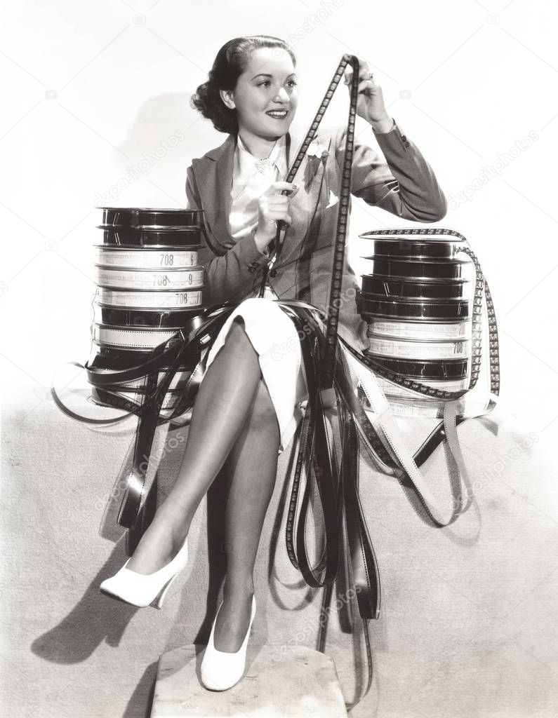 woman looking at film reel