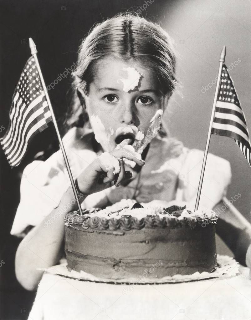 girl with American flags on cake