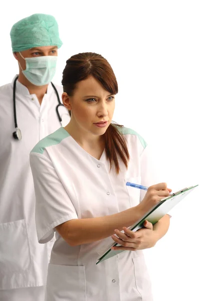 Doctor Wearing Cap Mask Young Nurse Writing Notes Royalty Free Stock Images
