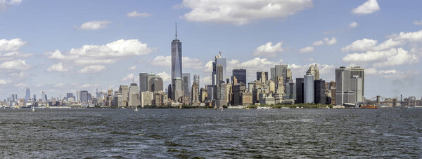 Syline of New York City Manhattan in summer on day with clouds in sky