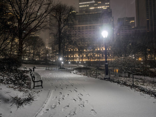 Central Park, New York City at night during snow storm near Christmas
