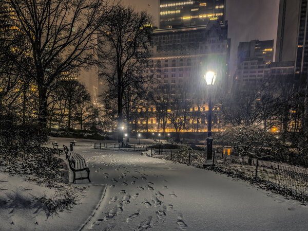 Central Park, New York City at night during snow storm near Christmas