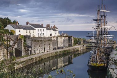Tall ships docked in historic Charlestown Harbour on the coast of Cornwall, England clipart