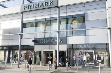MILTON KEYNES, UK - February 12, 2020. Exterior of a large Primark store and shoppers at MK1 retail park in Milton Keynes clipart