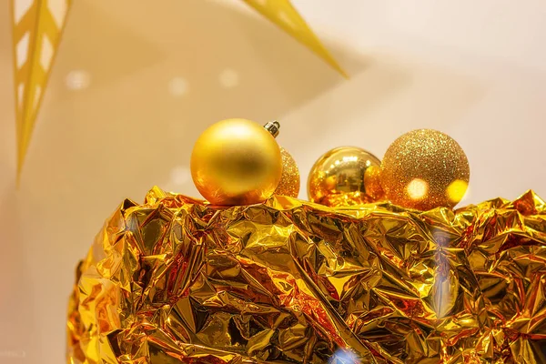 festive gold balls on a gold foil gift wrap