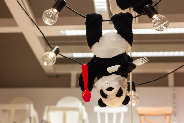 toy Panda hanging upside down a lamp for the nursery