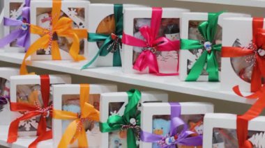 boxes with gifts on showcase .colored satin ribbon christmas