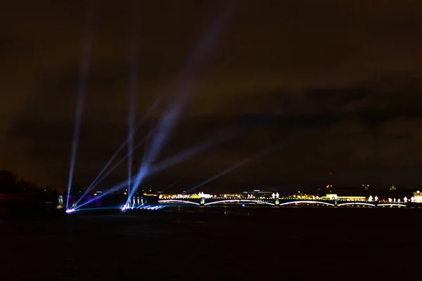 laser show projectors in the sky illuminated