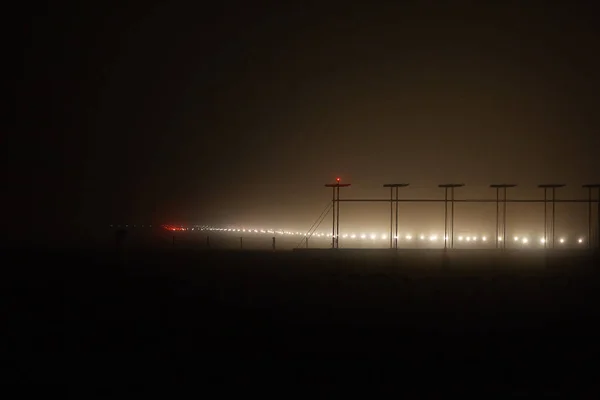 runway in the fog night and cancellation of flights