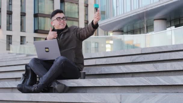 Young Male Asian Blogger Makes Selfie Captures Vlog Camera Communicates — Stock Video