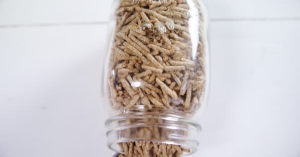 Close Cereal Bran Sticks Spilling Glass Jar — Stock Video