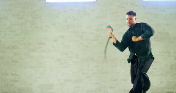 Kung Fighter Practicing Martial Arts Sword Fitness Studio — стоковое видео