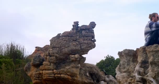 Zijaanzicht Van Man Zit Rock Zoek Door Middel Van Verrekijkers — Stockvideo