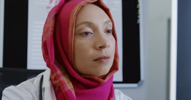 Visão Frontal Perto Uma Médica Mista Vestindo Hijab Rosa Sentada — Vídeo de Stock