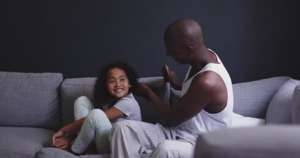 Vista Lateral Hombre Afroamericano Hija Sentados Sofá Juntos Mañana Sala — Vídeo de stock