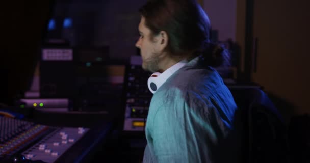 Portrait Caucasian Male Sound Engineer Ponytail Sitting Working Mixing Desk — Stock Video