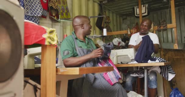 Front View Two African Male Tailors Township Workshop Sitting Sewing — ストック動画