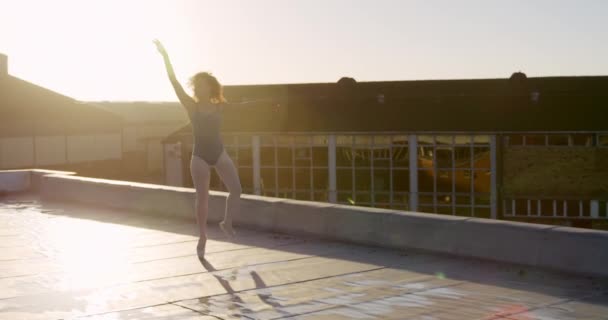 Side View Mixed Race Female Ballet Dancer Practicing Rooftop Sunrise — 비디오