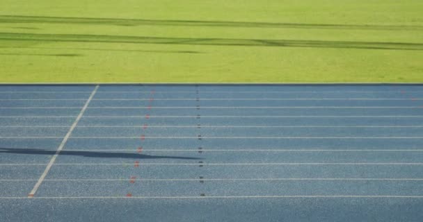 一个白人女运动员在体育场练习 在赛马场跑步 慢动作的侧视图 体育场的田径训练 — 图库视频影像