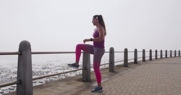 Side View Young Caucasian Woman Wearing Sports Clothes Headphones Stretching — 비디오