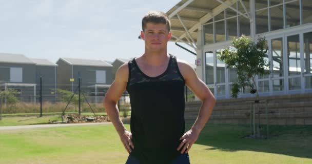 Portrait Caucasian Male Runner Wearing Black Vest Training Sports Field — Stockvideo