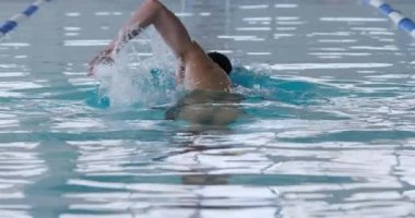 Kafkas erkek yüzücünün yüzme havuzunda yüzme yarışında şeritte yarışması, kelebek yüzüşü, yavaş çekimde